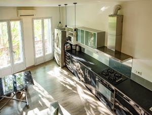 a kitchen with a stove and a counter top at LA PIVOINE in Vauvert