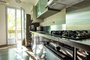 a kitchen with a stove and a counter top at LA PIVOINE in Vauvert