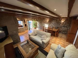 a living room with a couch and a table at Casa do Caseiro Muxía in Muxia