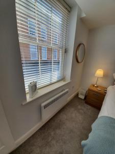 a bedroom with a bed and a window with a radiator at Ipswich Town Centre - Apartment 1 in Ipswich