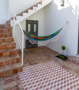 a staircase with a hammock in the middle of a room at Casa Vitória in São Brás de Alportel