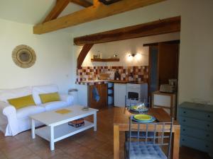 a living room with a couch and a table at Noisette and Co in Saint-Cyprien