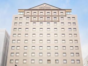 a large brick building with a clock on the front of it at Hotel Wing International Premium Tokyo Yotsuya in Tokyo