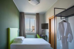 a hotel room with a bed and a window at Allegroitalia La Spezia 5 Terre in La Spezia