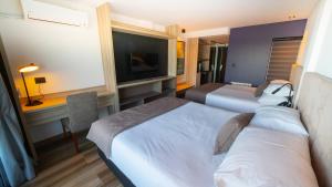 A bed or beds in a room at Neco Boutique Hotel