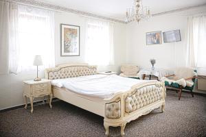 Un dormitorio con una cama grande y una lámpara de araña. en Stáj Newport, en Dolní Domaslavice