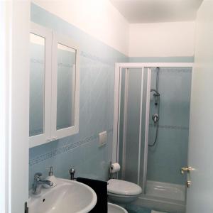 a bathroom with a sink and a toilet and a shower at Centralissimo appartamento a Numana in Numana
