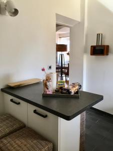 a kitchen island with a black counter top at Chez Andrea, Centre Historique Ajaccio in Ajaccio