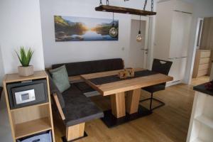 a living room with a table and a couch at Apartment Mayerhofer in Fulpmes
