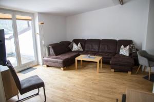 a living room with a couch and a table at Apartment Mayerhofer in Fulpmes