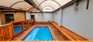 an indoor swimming pool with a balcony and an indoor poolvisor at Asda guesthouse in Mogwase