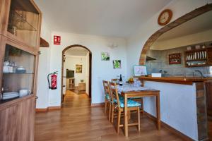 a kitchen with a table and chairs in a room at Casa Rural alto prado in Isora