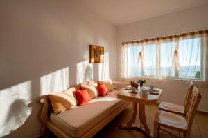a living room with a couch and a table at Vallais Villa in Imerovigli