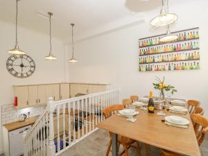 Un comedor con mesa y sillas de madera. en The Coach House, en Ventnor