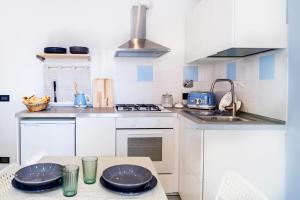 a kitchen with a table with plates on it at Nel Cuore di Santa in Santa Margherita Ligure +16 photos