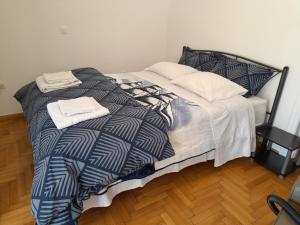 a bed with two towels on top of it at Alimos Studio Apartment in Athens