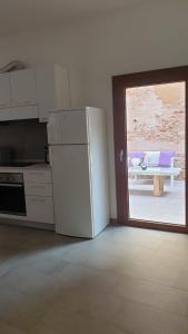 a kitchen with a refrigerator and a door to a patio at Venice Apartment with Private Courtyard in Venice