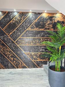 a wall mural with gold lines in a lobby at Nidus 101 in Souda