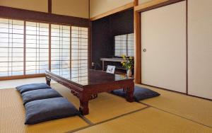 a room with a ping pong table and a mirror at OMISHIMA SPACE Omoya in Imabari