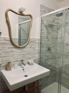 a bathroom with a sink and a mirror at Stellammare Apulian House B&B in Bari