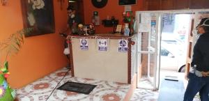 a kitchen with a refrigerator with stickers on it at Hotel Amayal in San Cristóbal de Las Casas