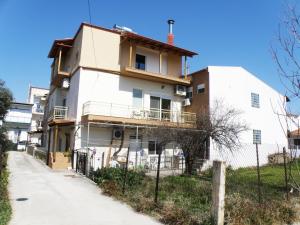 a white house on the side of a street at Thassosrent in Limenaria