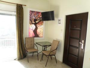 a room with a table and chairs and a window at Thassosrent in Limenaria