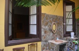 a bathroom with a sink and a stone wall at Casa Colonial Cejas in Santa Cruz de Tenerife