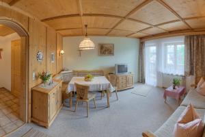 a living room with a table and a couch at Haus Singer in Bad Feilnbach