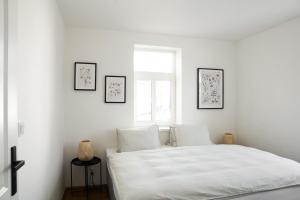 Un pat sau paturi într-o cameră la Apartmány Winkler