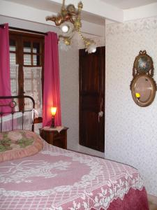 La Ferme Du Pressoir Guest House في Conteville: غرفة نوم مع سرير ونافذة مع ستائر وردية