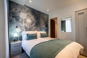 a bedroom with a large bed with a wall at 201@ Ryedale House in York