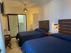En eller flere senger på et rom på Hotel Casa Azul