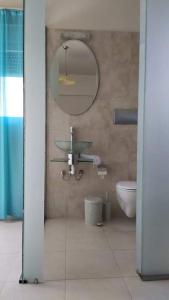 a bathroom with a sink and a mirror and a toilet at Villa Katerina in Ialyssos +38 photos