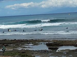 a group of people riding the waves in the ocean at Apartamento Playa vistas 2 in Los Cristianos