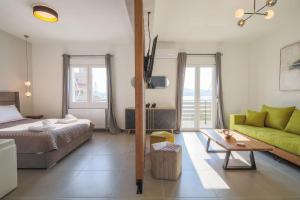 a living room with a bed and a green couch at *Oasis* Best View Jacuzzi New Central Apartment in Volos