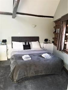 a bedroom with a bed with two towels on it at The Carriage House, Studio 3A in Bilbrough