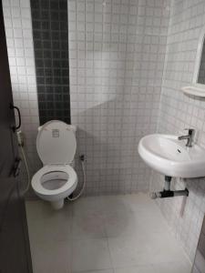 a bathroom with a toilet and a sink at JMD VILLA in Vagator
