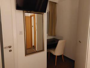 a living room with a television and a door at La Perle Hotel in Jerusalem
