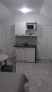 a small kitchen with a table and a microwave at EMA HOUSE in Zadar