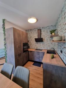 a kitchen with wooden counters and a brick wall at Gemini Suites in Kaštela
