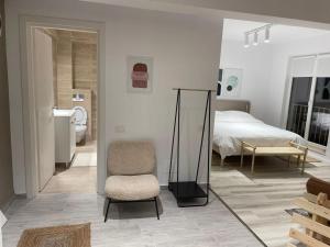 a bedroom with a bed and a chair and a mirror at Shi Mi Junior Suite in Iaşi