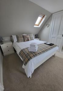 a bedroom with a bed and a skylight at An Cnoc Bed & Breakfast in Staffin