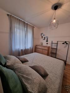 a bedroom with a bed with pillows on it at Gemini Suites in Kaštela