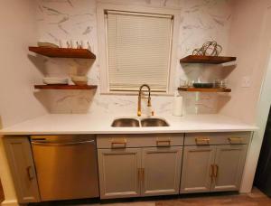 a kitchen with a sink and a window at The Jasmine On Main in Little Rock