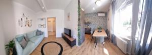 a living room with a couch and a table at Gemini Suites in Kaštela