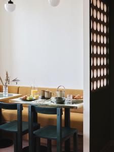 a table with a tray of food on it at Hotel Orphée - Orso Hotels in Paris