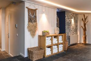 a room with a shelf of towels on a wall at The Originals Boutique La Villa Ouest & Spa in Saint-Palais-sur-Mer