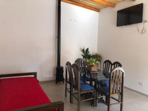 a dining room with a table and chairs and a television at Espacio Encanto in Humahuaca