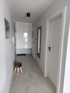 a room with a hallway with a door and a stool at Dream Apart in Szklarska Poręba